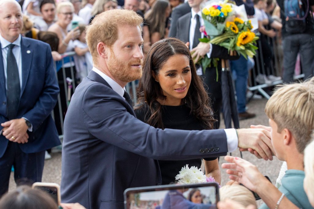 Prince Harry and Meghan Markle greet viewers outside Windsor Castle.