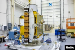 DART team members carefully inspect the spacecraft prior to vibration tests in July 2021 (Image credit: NASA/Johns Hopkins APL/Ed Whitman)