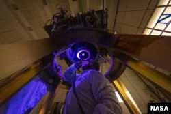 DART team members install and inspect the DART spacecraft's only instrument - the Didymos Reconnaissance Camera and Asteroid Navigation Camera (DRACO) - on the spacecraft in June 2021 (Image credit: NASA/Johns Hopkins APL/Ed Whitman)